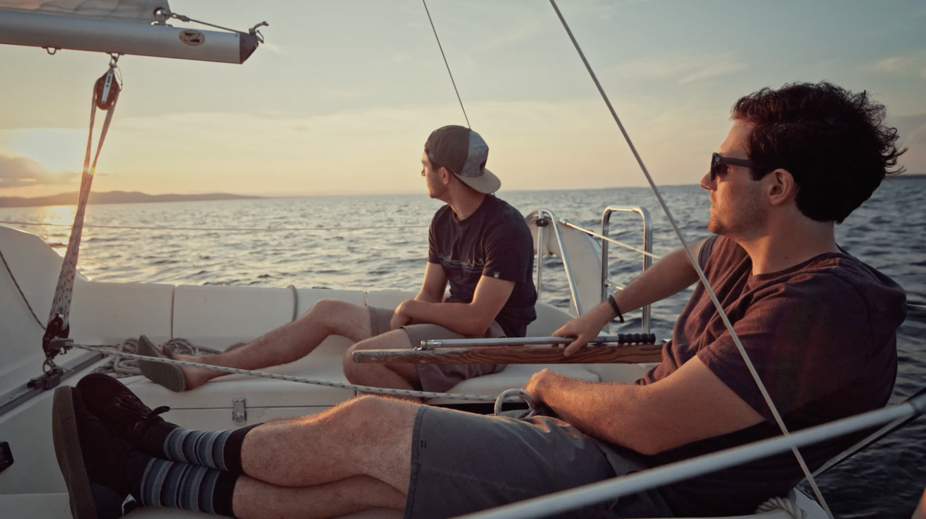 two men on a boat at sunset